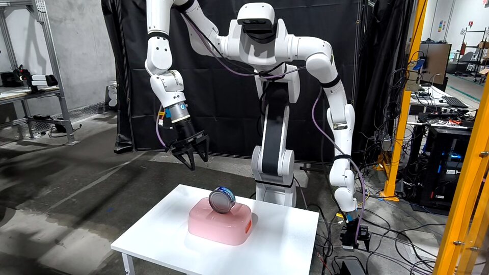 Dexmate Vega Pro wheeled humanoid autonomously reaching toward a tuna can on a small table